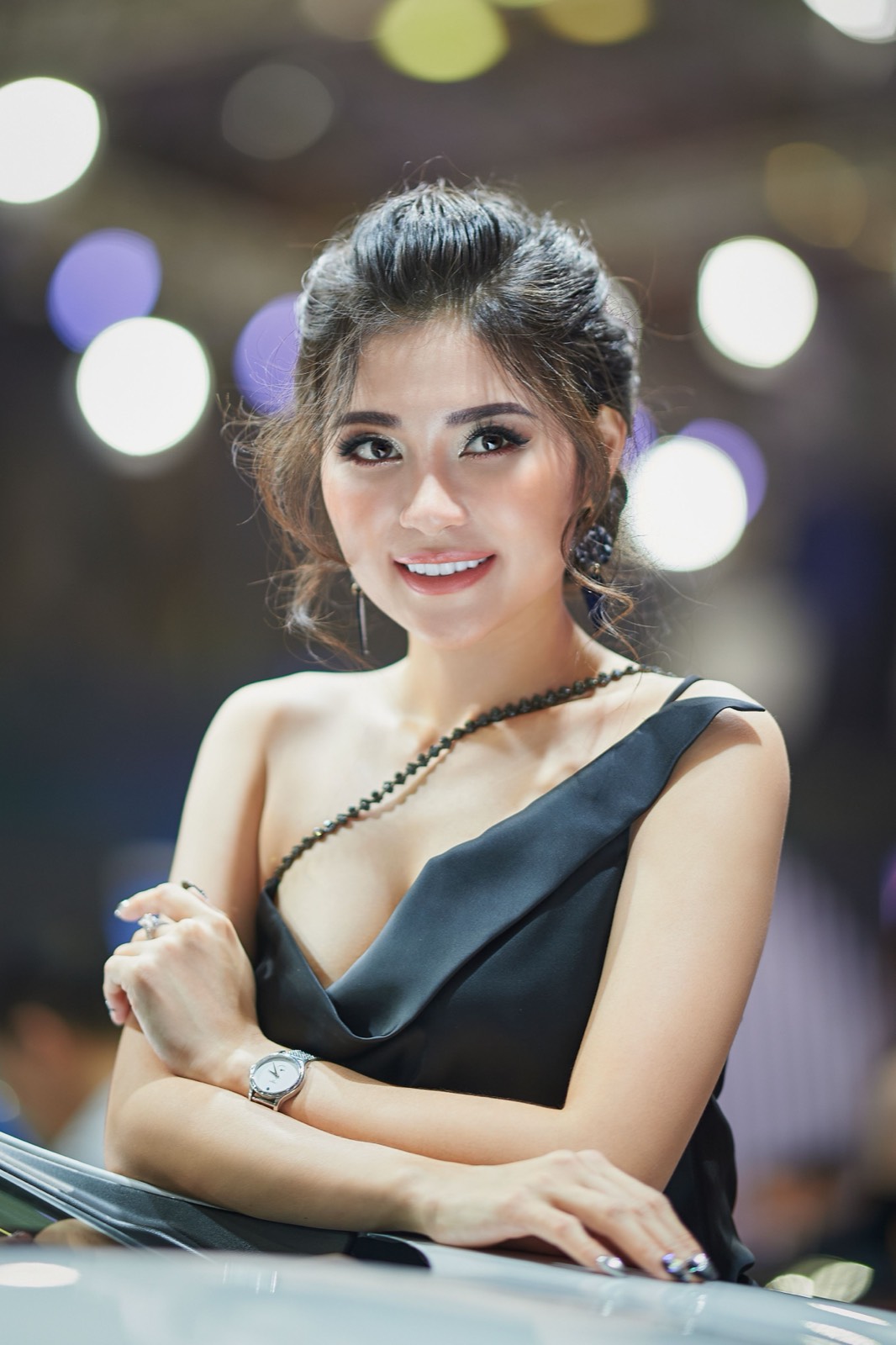 Thai woman in a black dress smiling